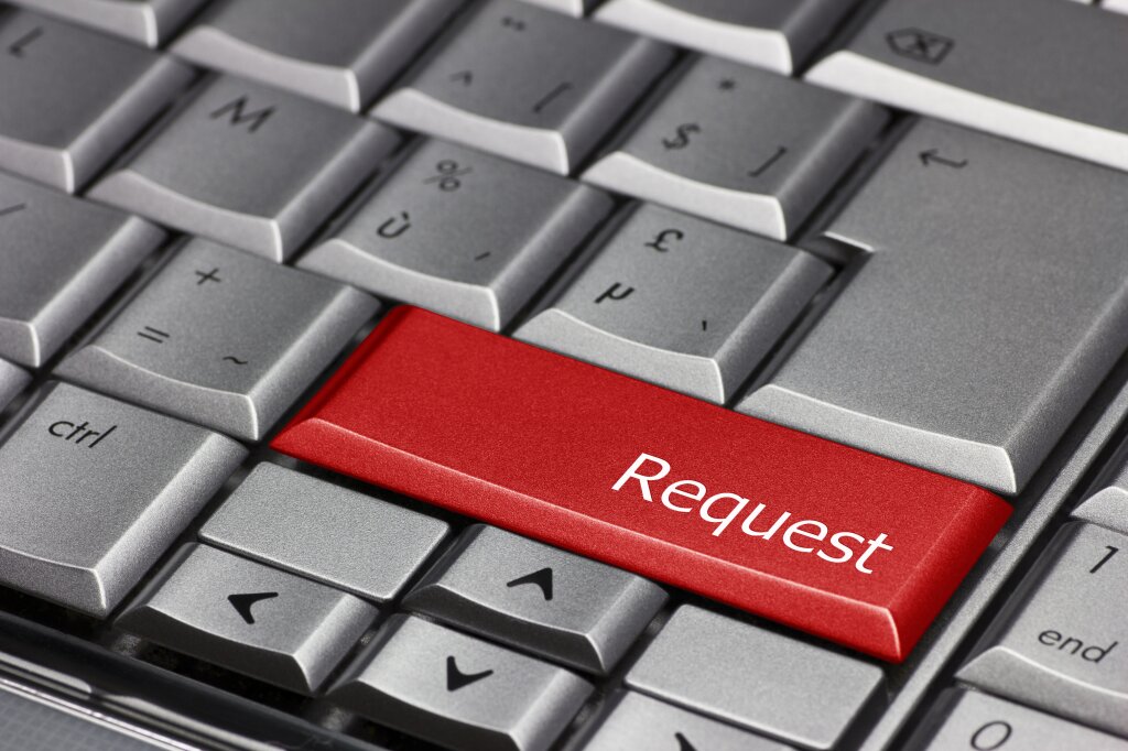 A computer keyboard with a key saying request which is in red.
