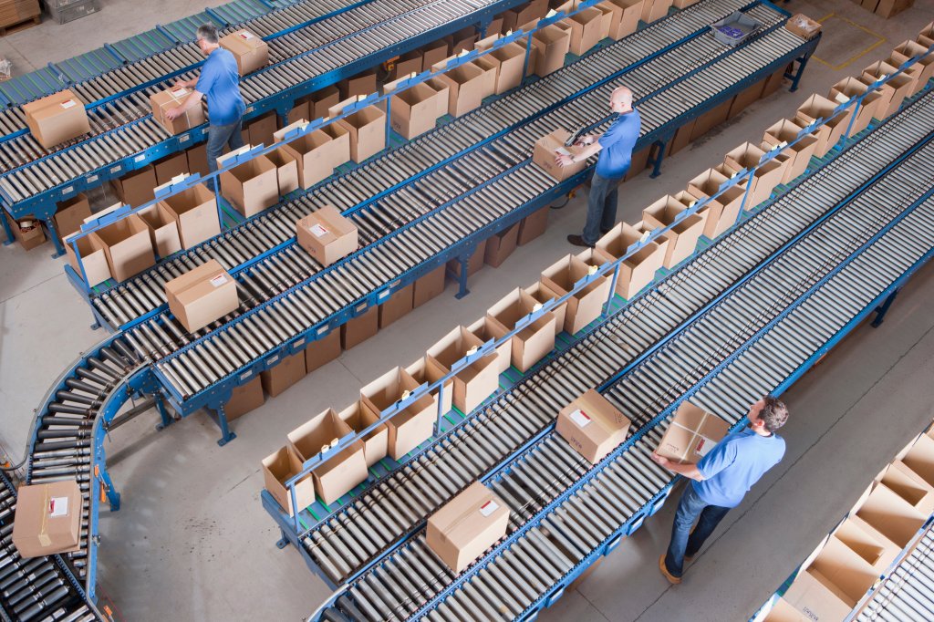 People packing boxes in a warehouse.
