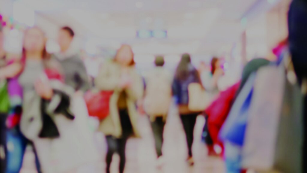 Blurred photo of people in a shopping centre.