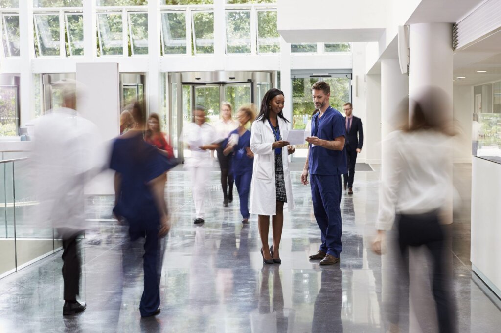 Doctors looking at a document in a hospital reception area.