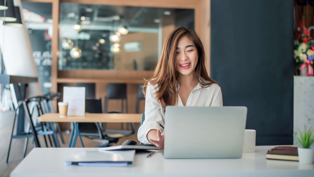 Woman working on a laptop.