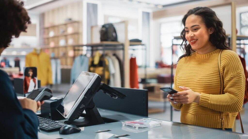 Woman paying for an item at a checkout.