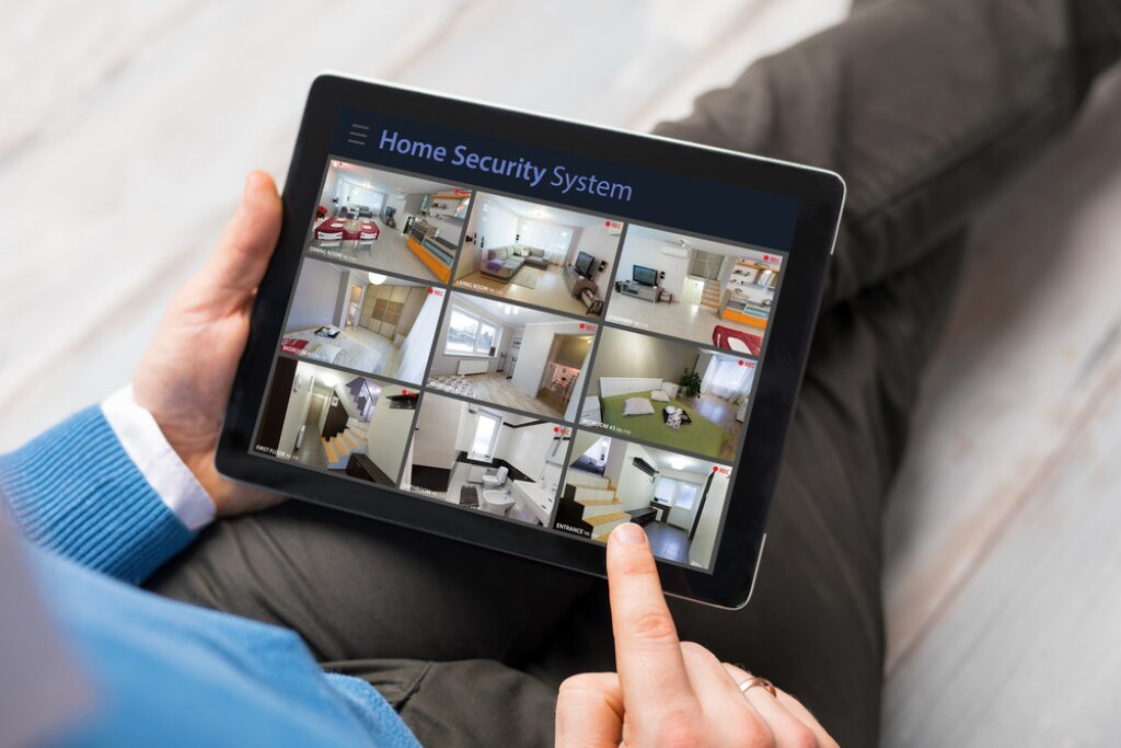 Image of a home security application on a mobile tablet with multiple camera feeds.