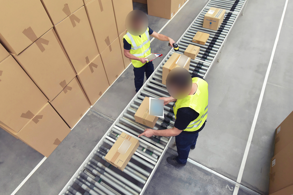 Image of a warehouse and workers packing.